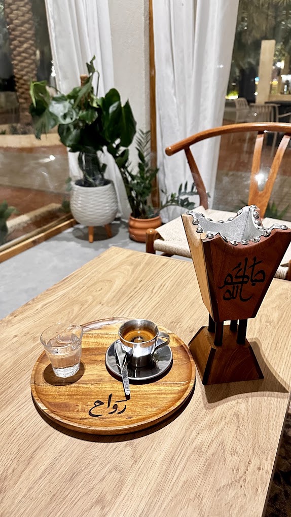 Espresso and water on a wooden rawah tray