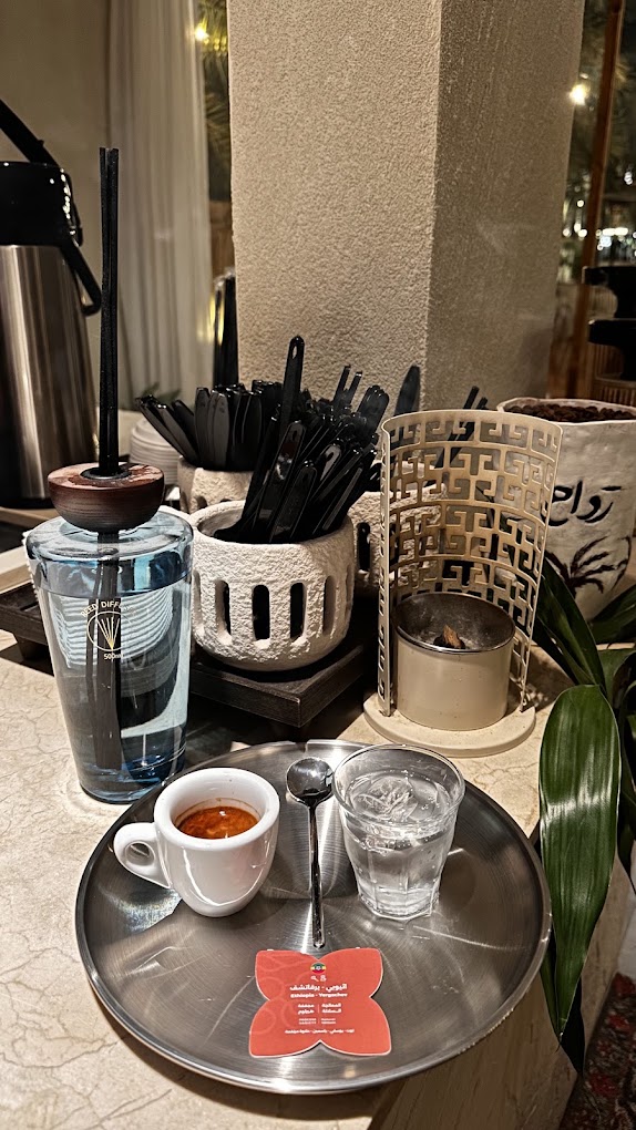 Espresso and water on a steel rawah tray