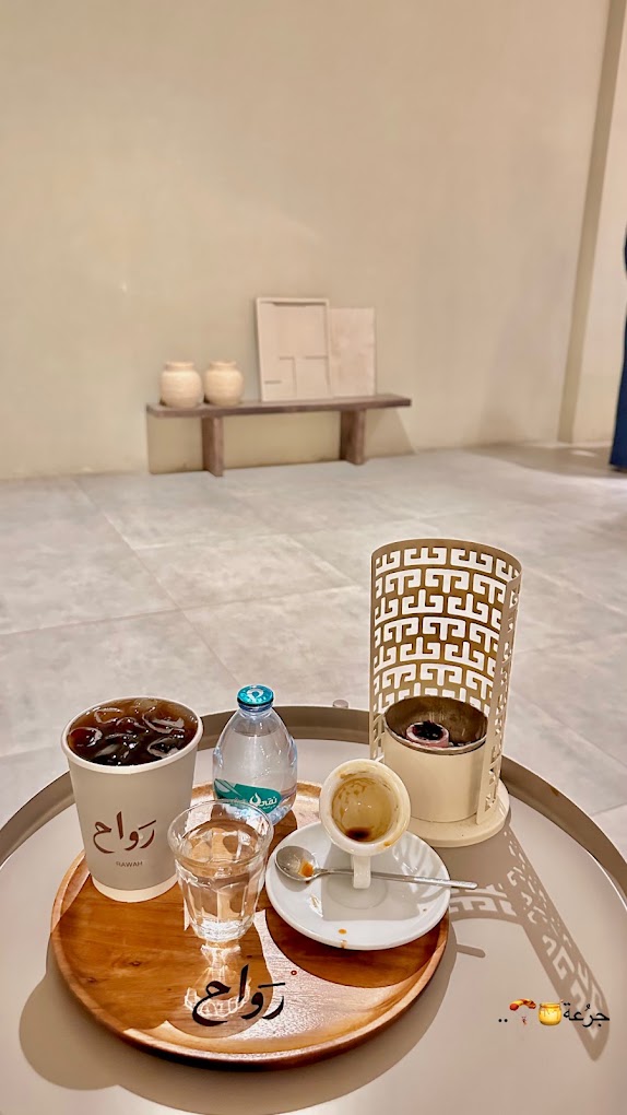 Iced drip, espresso and a lantern candle on a rawah tray