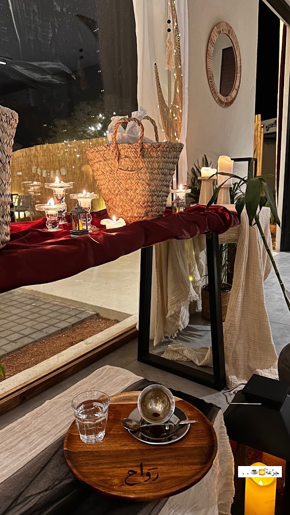 Candlelit corner at rawah with Saudi coffee on a wooden tray